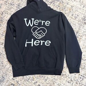 Black Hoodie with 'We're Here' Design